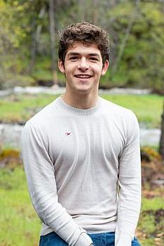 young man in front of a green background