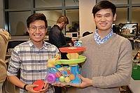 Two students holding a toy that they modified to be more accessible to children with disabilities.