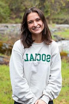 young woman in front of a green background