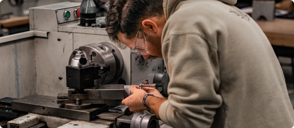 A student is machining a part using a lathe.